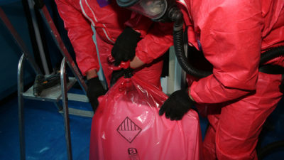 Team working with asbestos removal bags